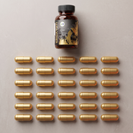 Thirty gold Kridavati capsules laid out in a six by five grid below the bottle, showing one month's supply.