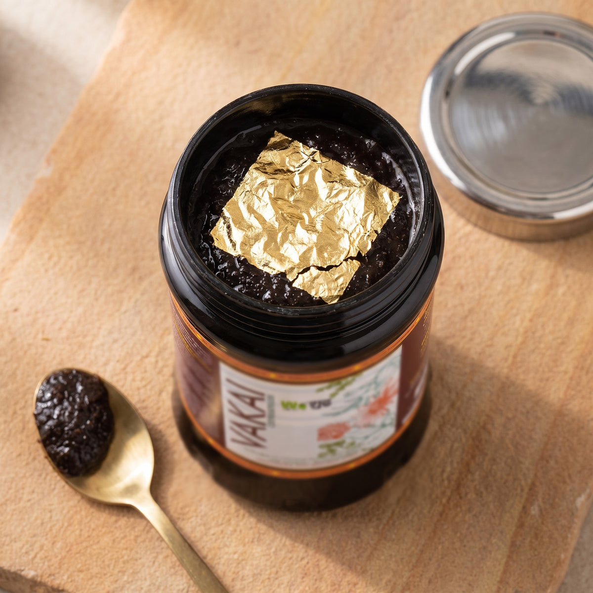 Open jar of Vakai Chyawanprash with gold varq on top
